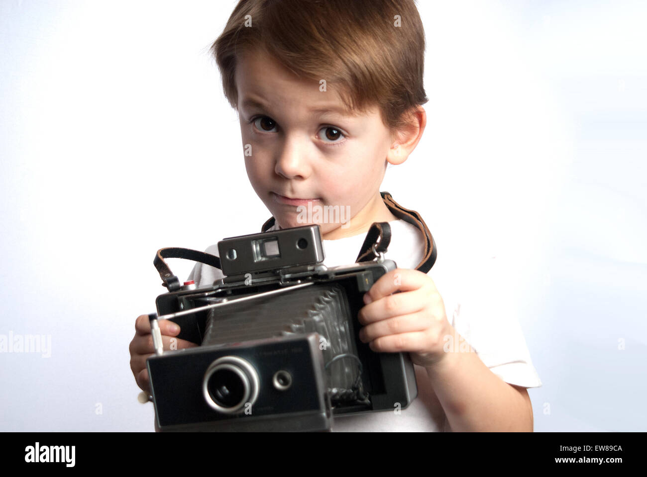 young child holding a instant camera on a white background Stock Photo ...