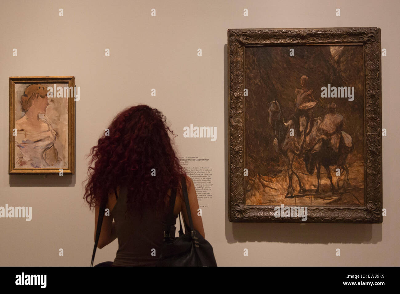 A visitor at the press preview looks at the painting 'Don Quixote and Sancho Panza' by Honore Daumier. The Courtauld Gallery presents Unfinished ... Works from The Courtauld Gallery, the annual Summer Showcase which highlights some of the Courtauld's outstanding permanent collection. This special display focuses on the theme of the 'unfinished' artwork, bringing together paintings, drawings, prints and sculpture from the Renaissance to the early 20th Century that have all been described as 'unfinished'. The display will run from 18 June to 20 September 2015. Stock Photo