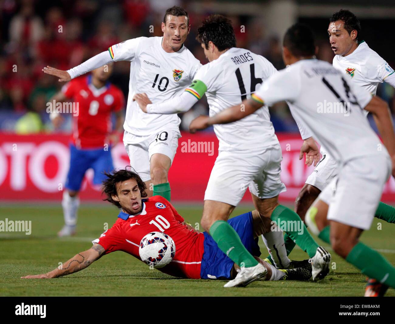 Santiago, Chile. 19th June, 2015. Chile's Jorge Valdivia (Below) vies with Bolivia's Ronald Raldes (3rd R) during the Group A match of the Copa America Chile 2015, held in the National Stadium, in Santiago, Chile, on June 19, 2015. Chile won 5-0. Credit:  Guillermo Arias/Xinhua/Alamy Live News Stock Photo