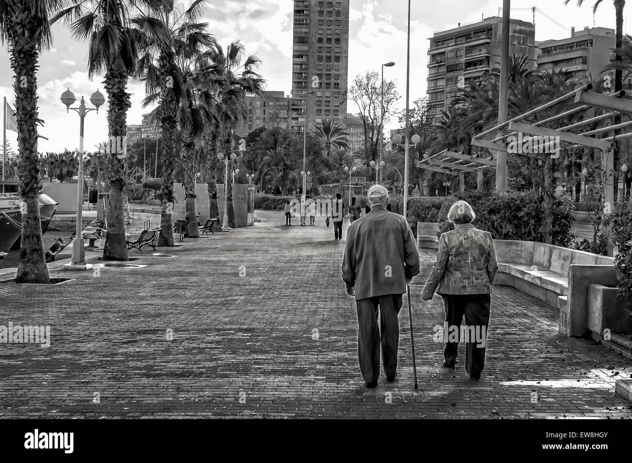 -The 3rd Age- Couple of 3rd age walking in promenade, Alicante (Spain). Stock Photo