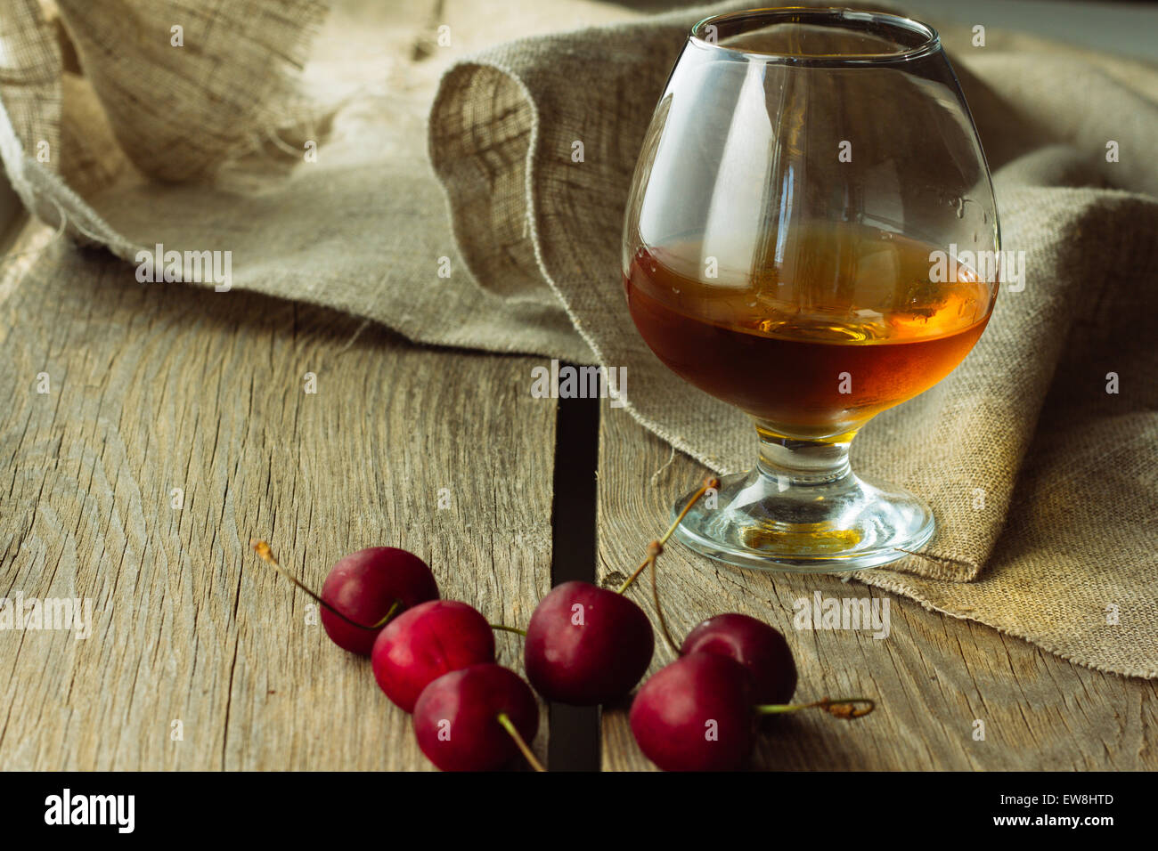 Brandy glass and black cherry horizontal selective focus Stock Photo