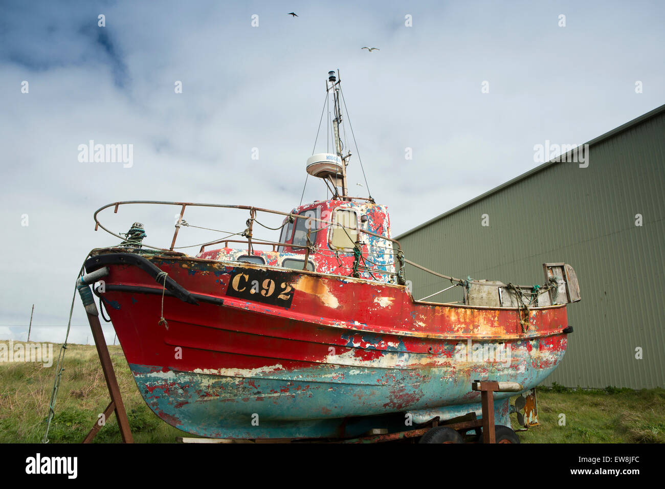 Ireland, Co Wexford, Kilmore Quay, colourful old fishing boat above the beach Stock Photo