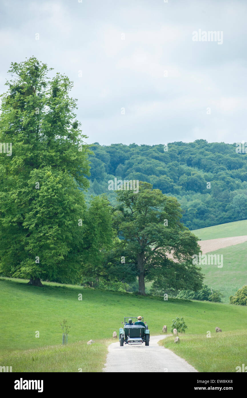 A classic scene of a classic car singer car driving through rolling English rural countryside Stock Photo