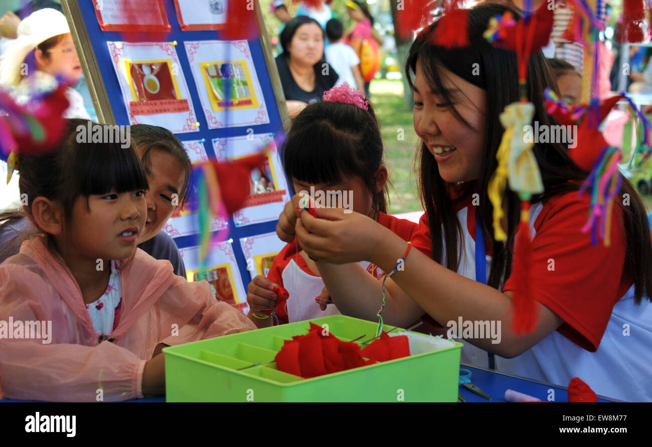 Beijing, China. 20th June, 2105. Children learn to make sachets to mark the Dragon Boat Festival, in Beijing, China, June 20, 2105. The Dragon Boat Festival, also known as Duanwu, is celebrated annually on the fifth day of the fifth month of the Chinese lunar calendar, which falls on June 20 this year. Credit:  Li Xin/Xinhua/Alamy Live News Stock Photo