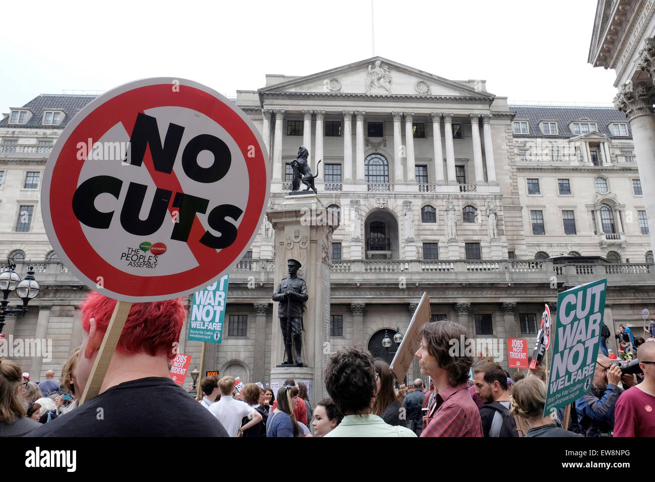 A protester outside the Bank of England holds a placard reading ' No Cuts' Stock Photo