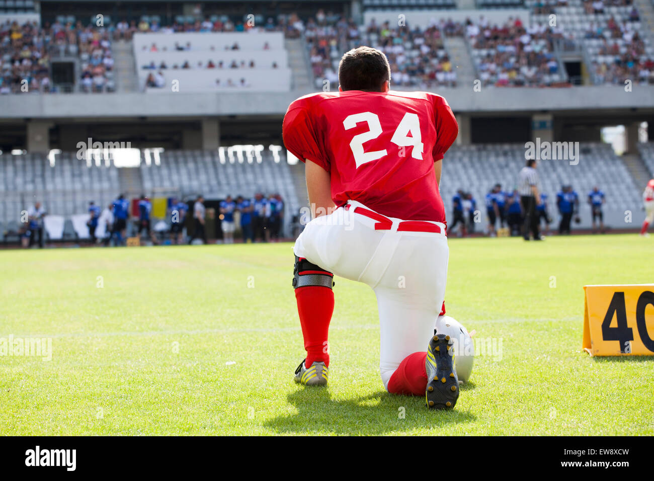 American football player on its knee Stock Photo Alamy