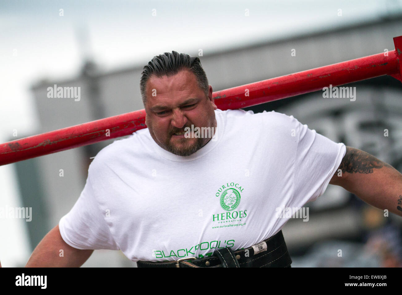 St Johns Square, Blackpool, Lancashire. 20th June, 2015  Dale Peters a weightlifter competitor, facial grimace at the Charity Strongman event which is hosted by Blackpool BID. Blackpool's Strongest Man Competition kicked off National Armed Forces Week in style with Ex Forces Personnel and Civilians alike proving themselves in strong man events to win the male weight lifter coveted, virility, manliness, maleness, vigour, strength, muscularity, ruggedness, toughness, robustness masculinity title. Stock Photo