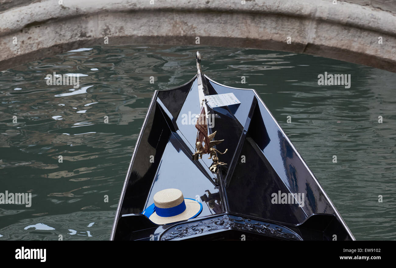 Straw hat of a gondolier with blue ribbon on gondola passing under bridge Venice Veneto Italy Europe Stock Photo