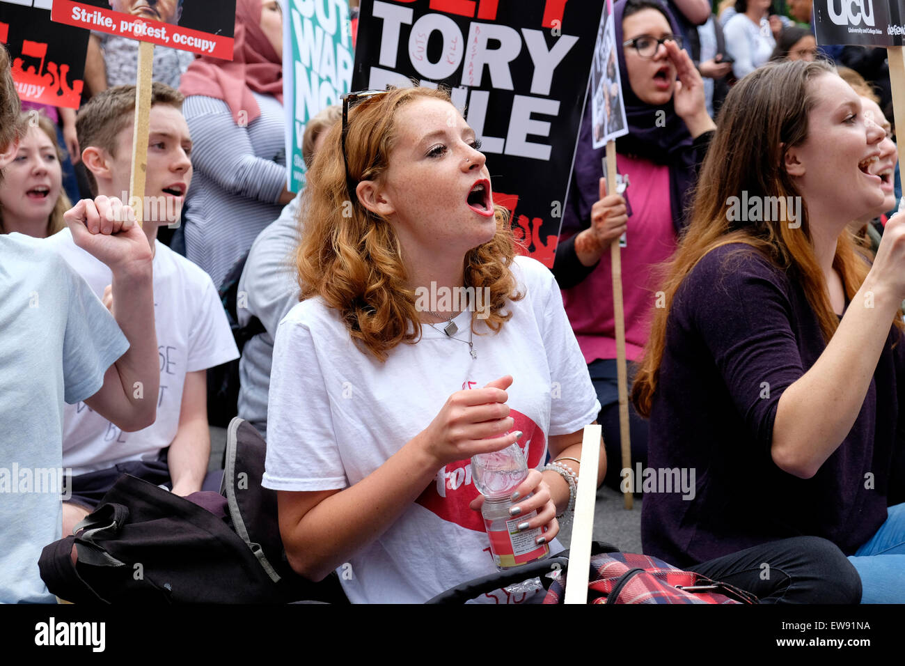 Young people protest outside Downing street, against austerity Stock Photo