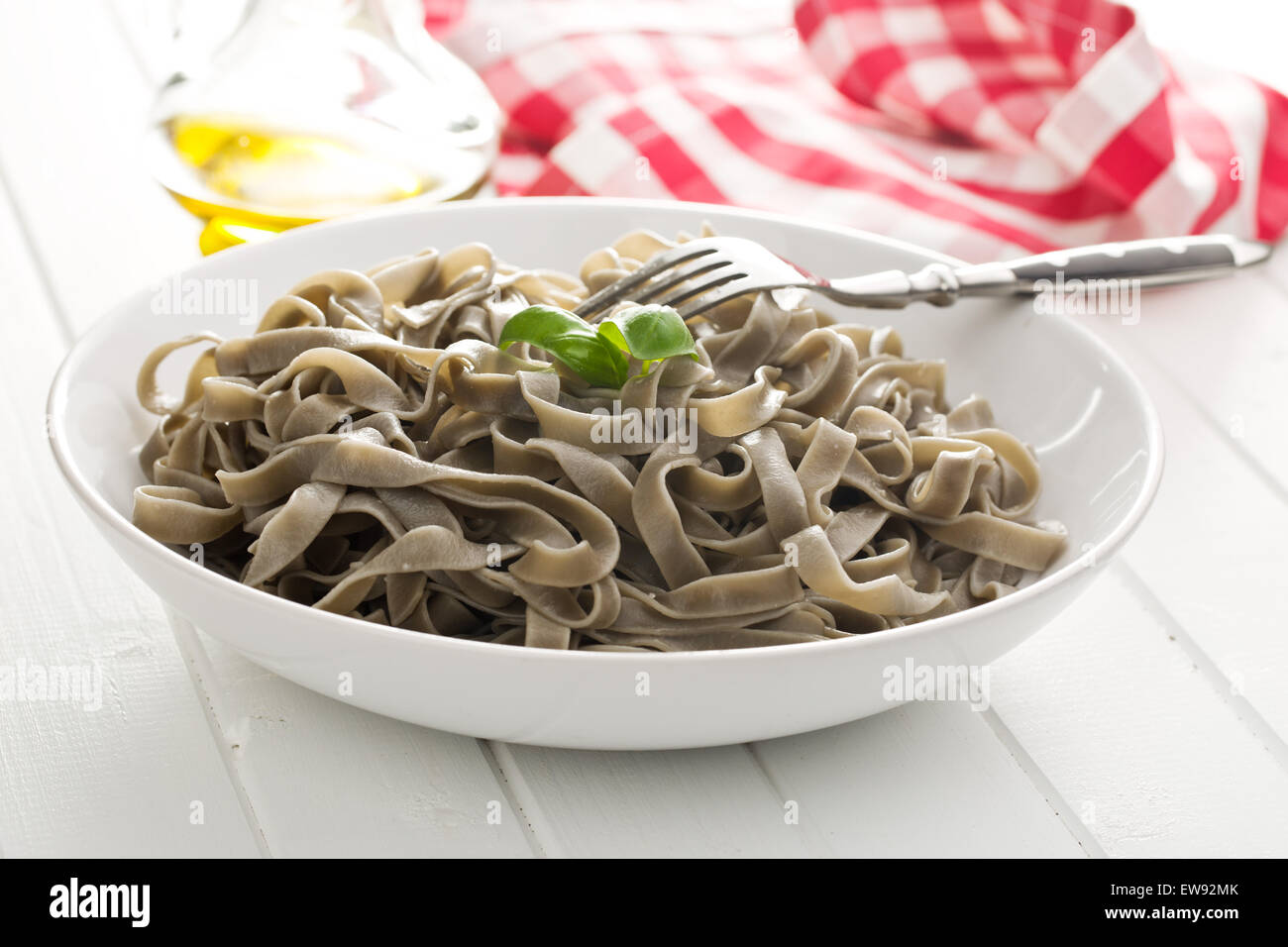 cooked black tagliatelle pasta on plate Stock Photo Alamy