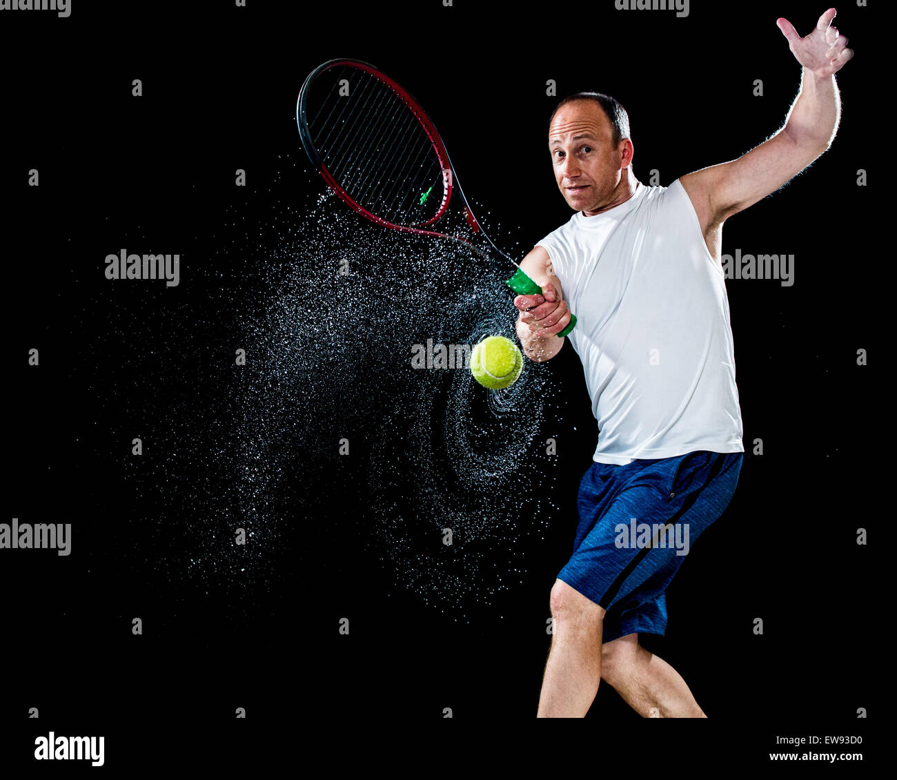 Tennis action shot. Forehand. Studio shot over black. Stock Photo