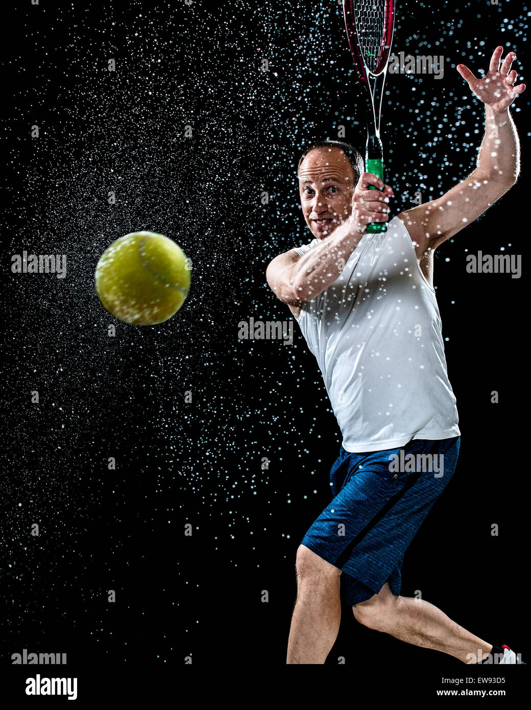 Tennis action shot. Forehand. Studio shot over black. Stock Photo