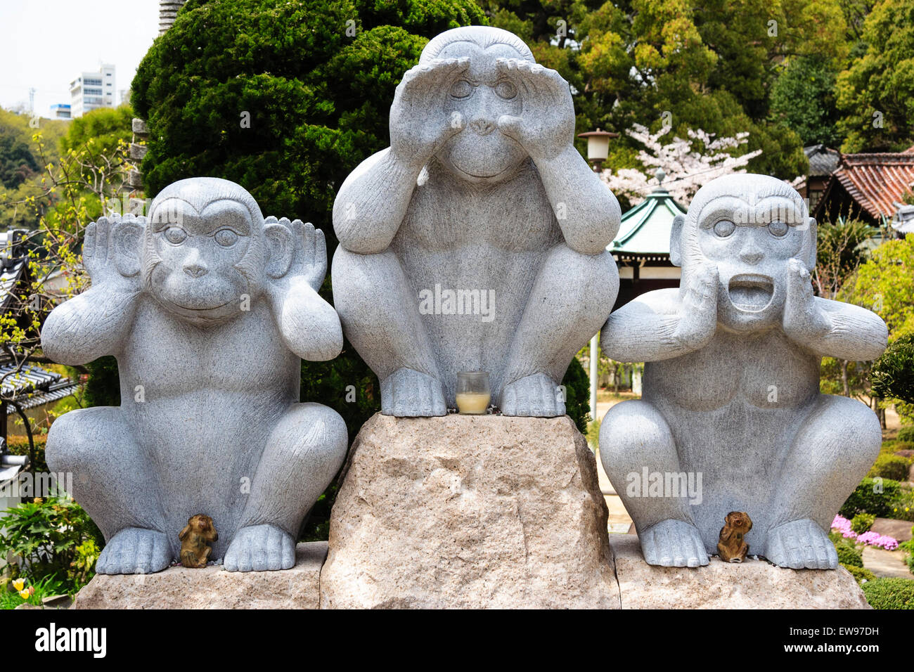 Japan, Onomichi, Taisanji Temple. Three wise monkey statue with hands clasped around mouth, eyes, and ears as in see, hear and speak. Stock Photo