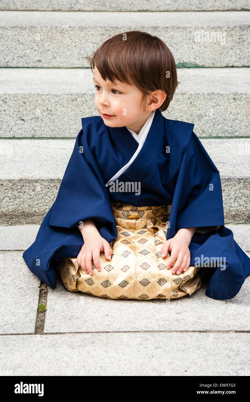 Japan, angelic 5 year old Caucasian child, boy, in kimono sitting, kneeling  on stone slabs with steps behind. Part of coming of age ritual, 3-5-7 Stock  Photo - Alamy