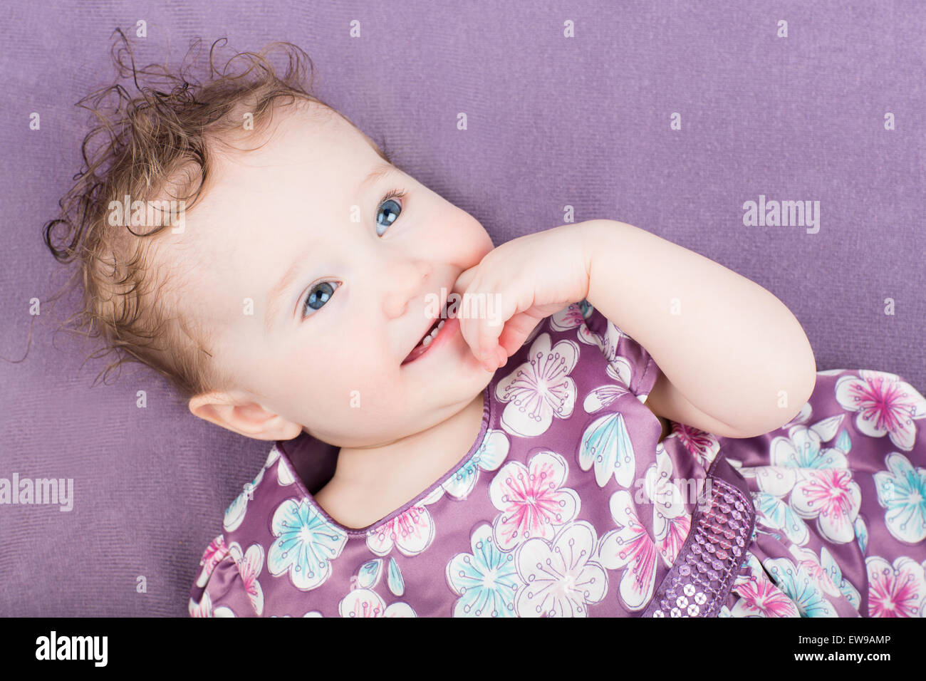 Beautiful little girl in a purple dress Stock Photo - Alamy