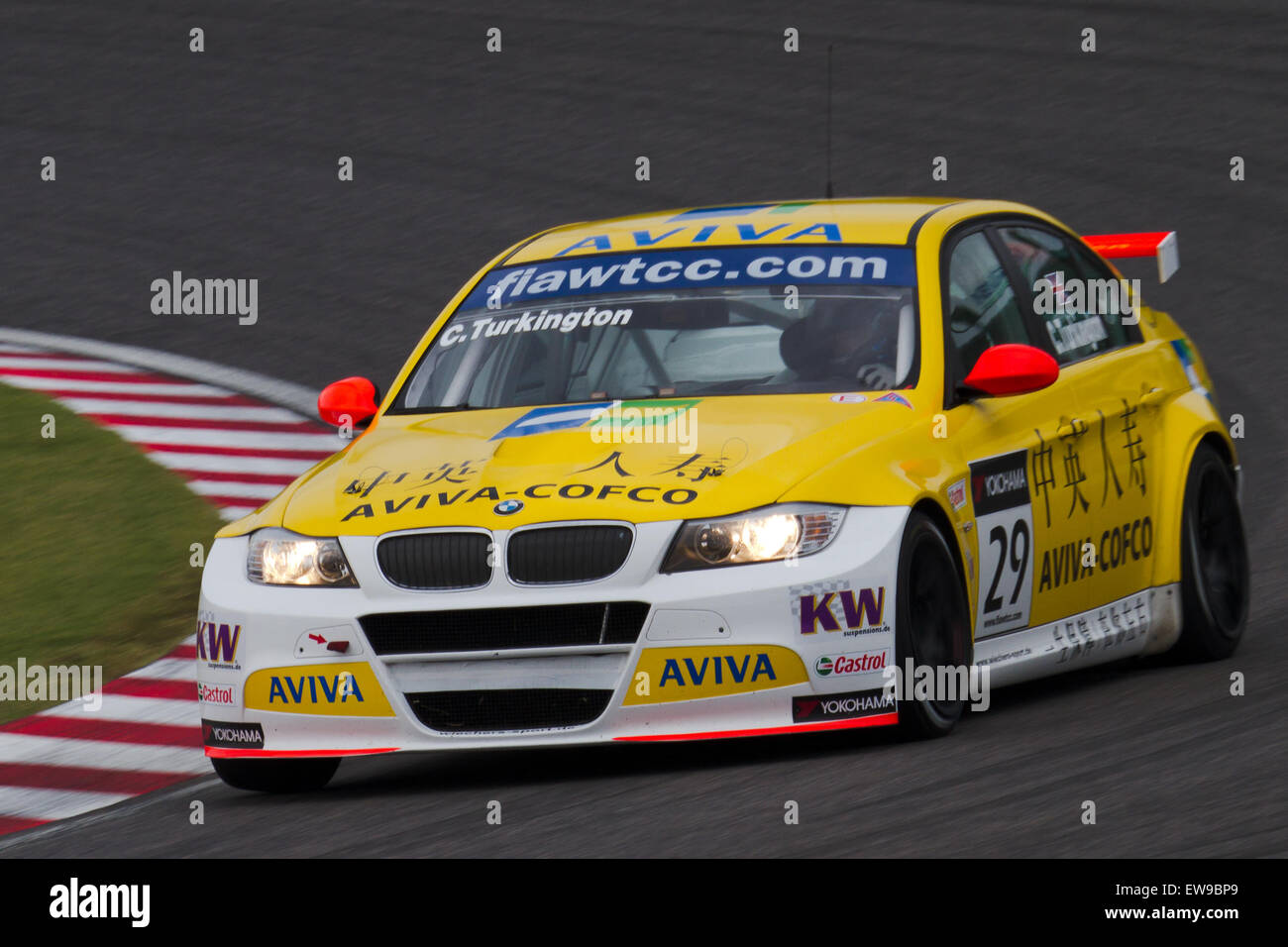 Colin Turkington competes in the 2011 WTCC Race of Japan during the qualifying rounds. The image captures his car in action, showcasing his skills on the track and highlighting the dynamic nature of touring car racing. Stock Photo