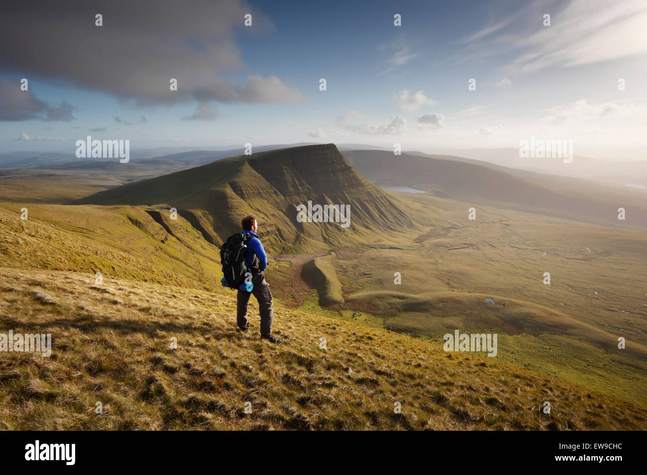 Hiker taking a breather on Fan Foel while heading for Picws Du. The Black Mountain. Brecon Beacons National Park. Carmarthenshir Stock Photo