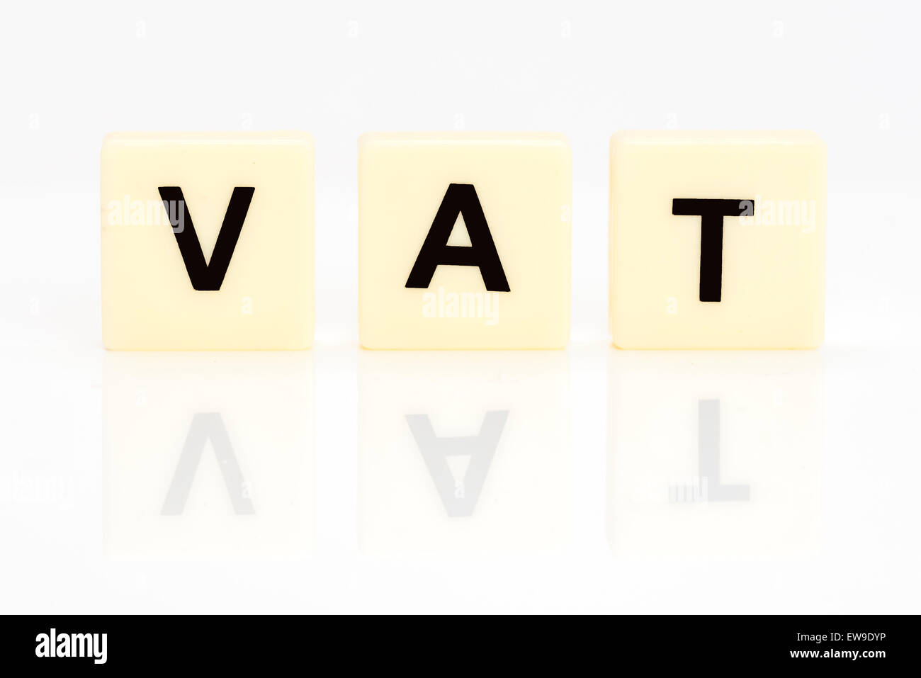 Generic letter tiles on a white background with reflection spelling the word VAT Stock Photo