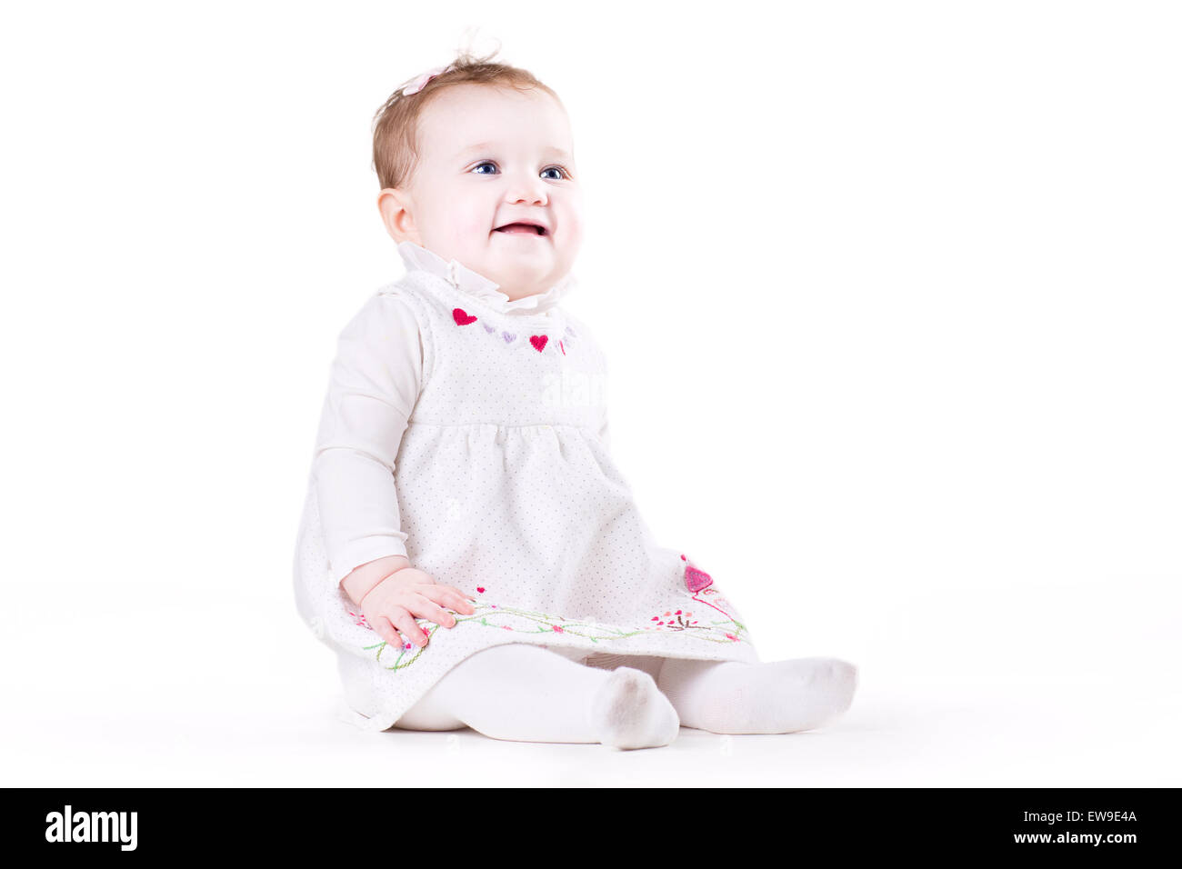 Cute baby girl in a white dress Stock Photo - Alamy