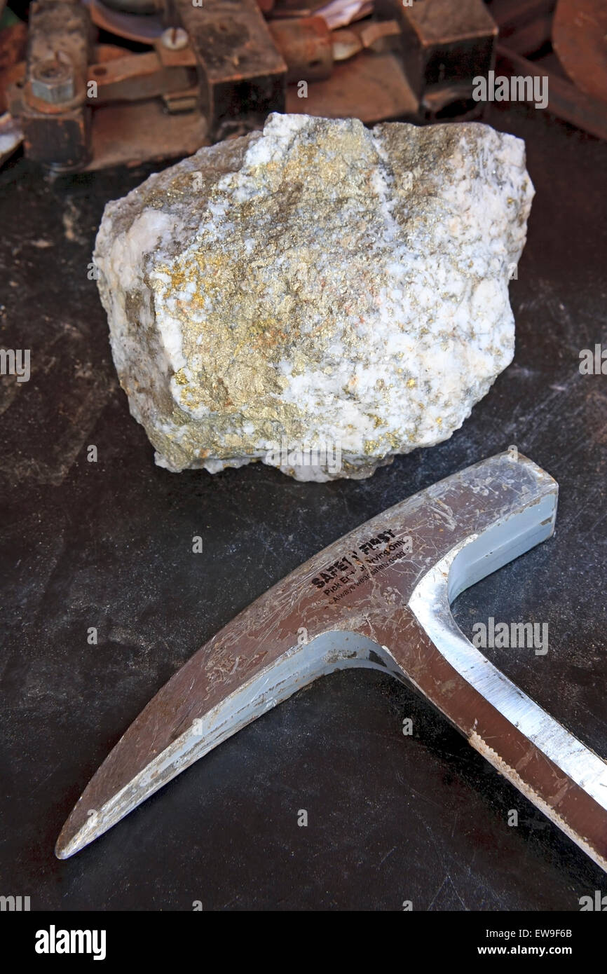 Mining exploration concept with mineral ore and rock hammer Stock Photo