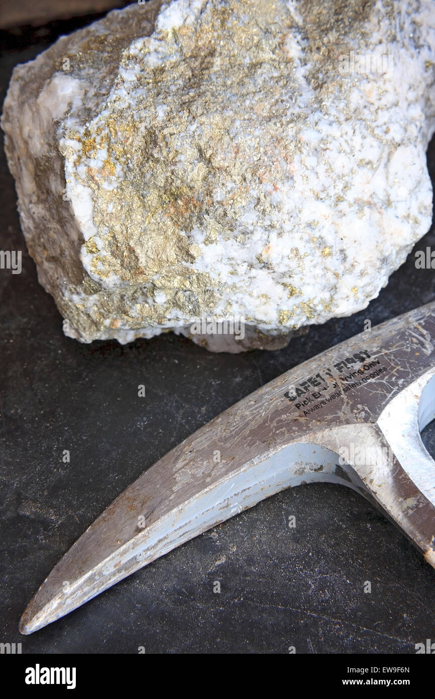 Mining exploration concept with mineral ore and rock hammer Stock Photo