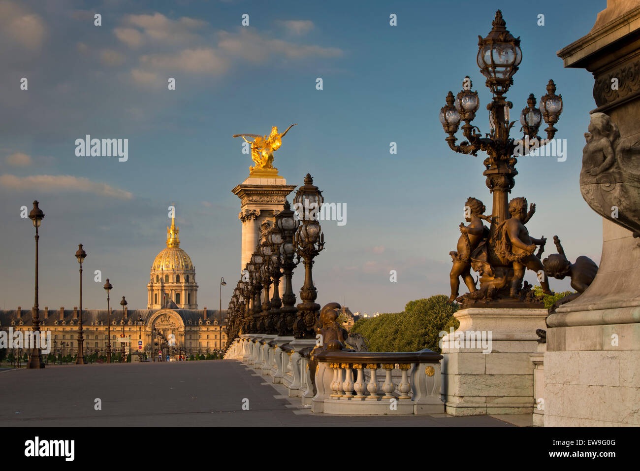 Dawn along the ornate Pont Alexandre III with Hotel des Invalides beyond, Paris, France Stock Photo