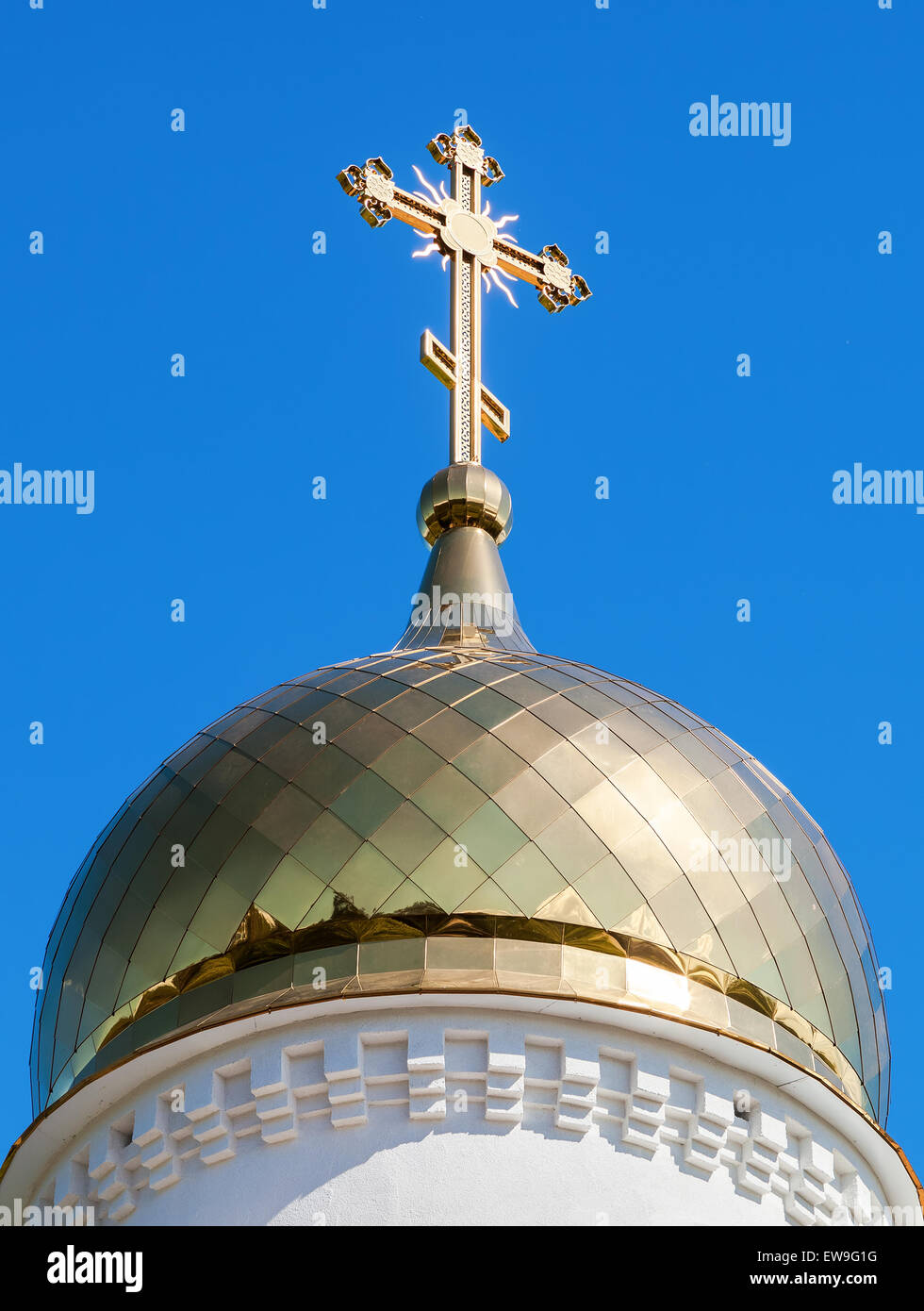 Golden dome of Russian orthodox church with cross against blue sky ...