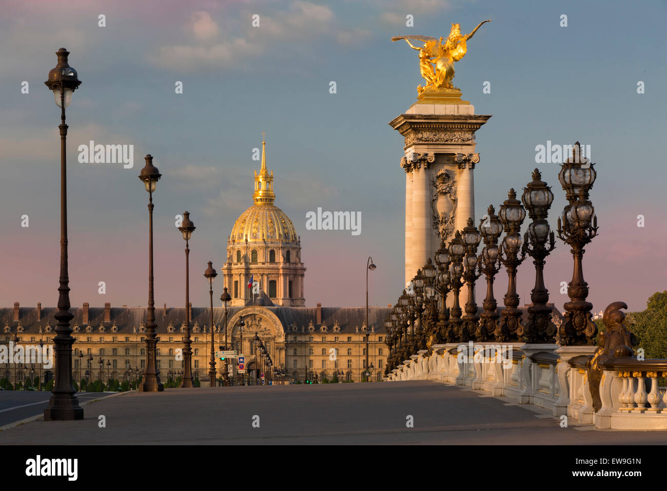 Dawn along the ornate Pont Alexandre III with Hotel des Invalides beyond, Paris, France Stock Photo