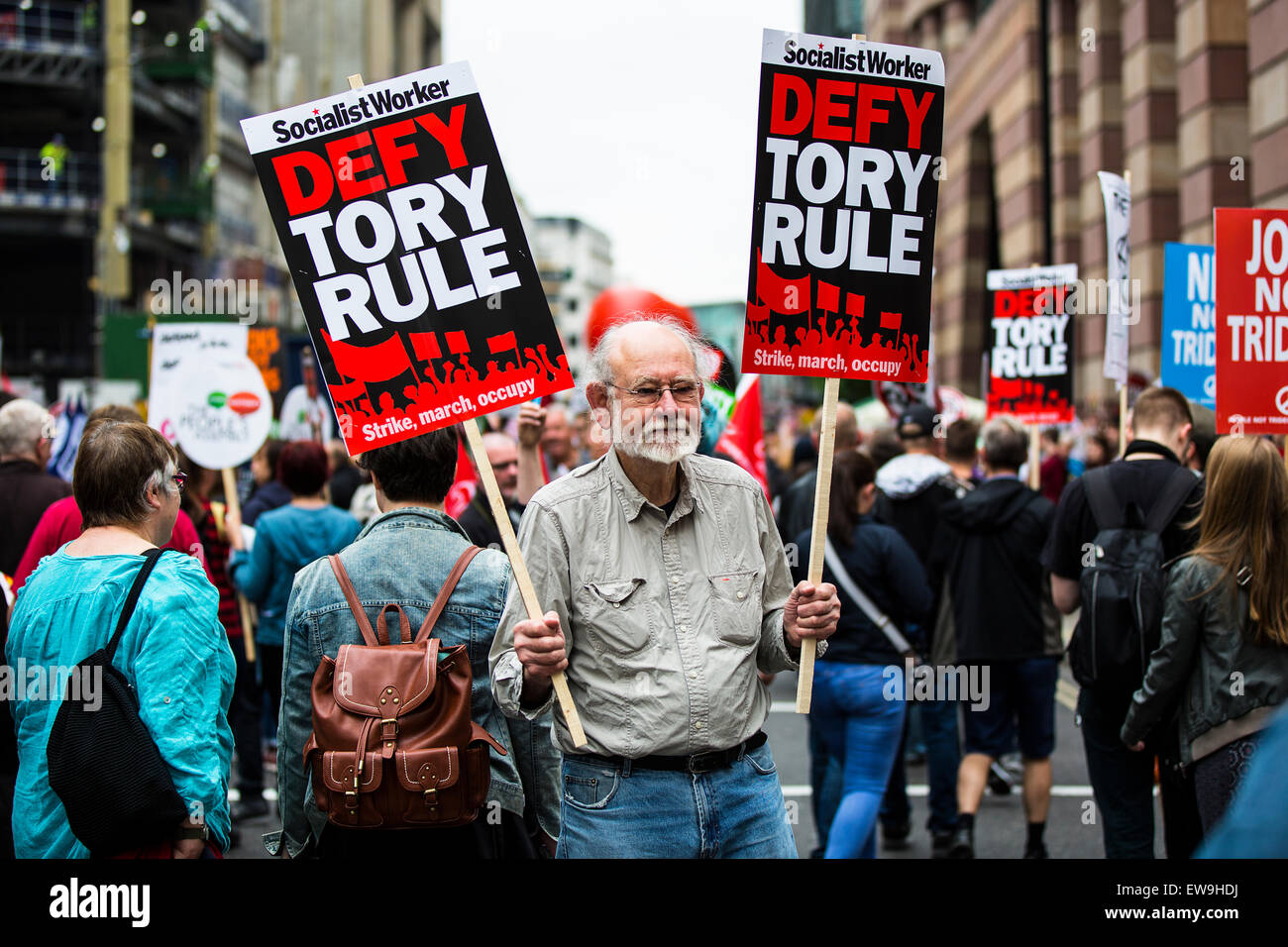 London, UK. 20th June, 2015. A man holds two placards saying 'defy Tory rule'.  London, UK.   20th March 2015. Credit:  Redorbital Photography/Alamy Live News Stock Photo