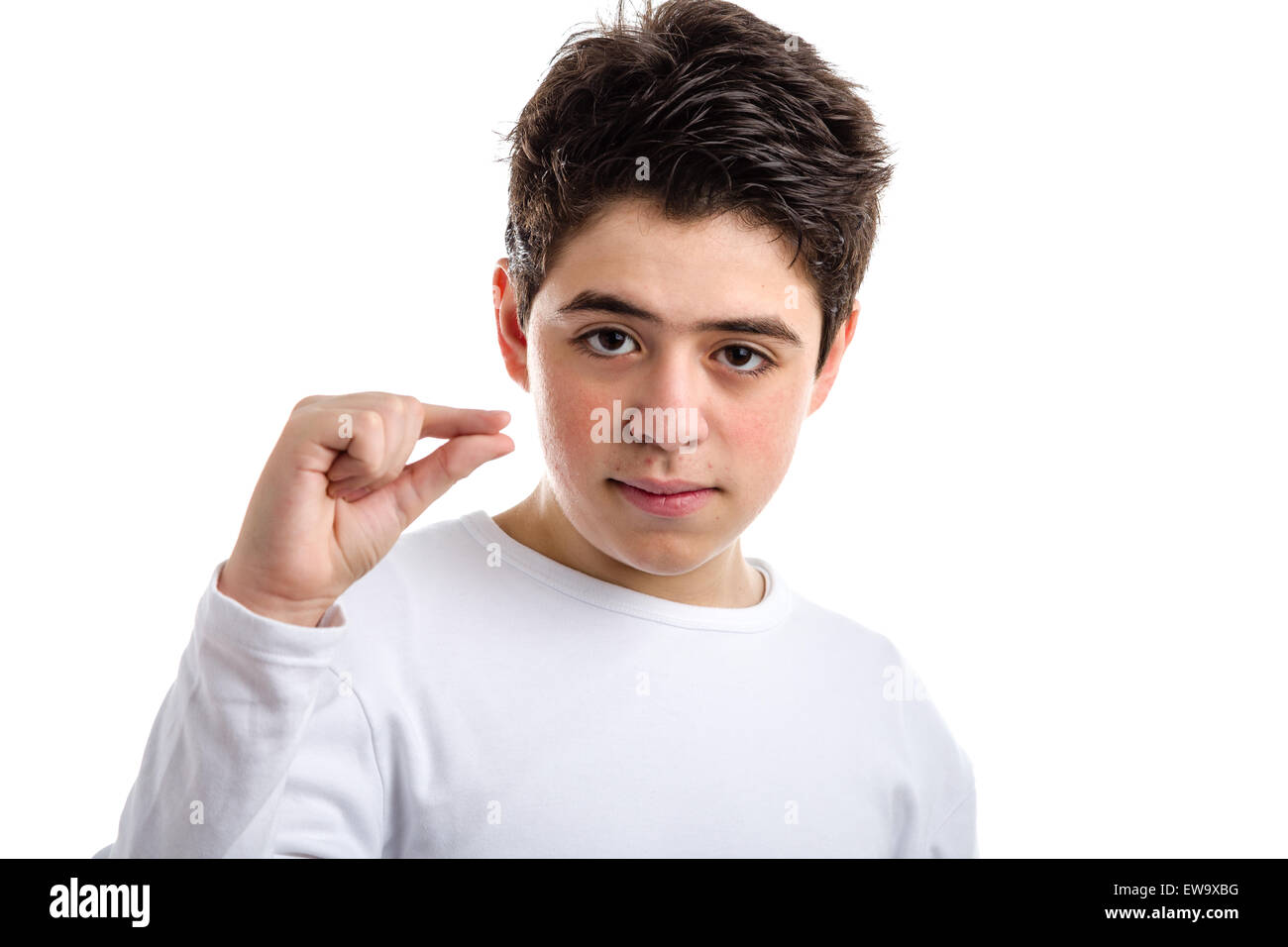 Caucasian young boy with acne in a white long sleeve t-shirt making pinching gesture with the thumb and index finger Stock Photo