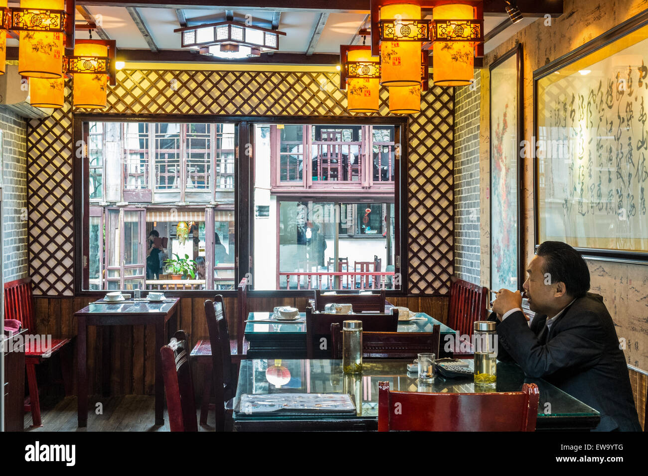 Chinese man eating alone in a traditional Chinese restaurant in the historic scenic Zhouzhuang water town, China Stock Photo