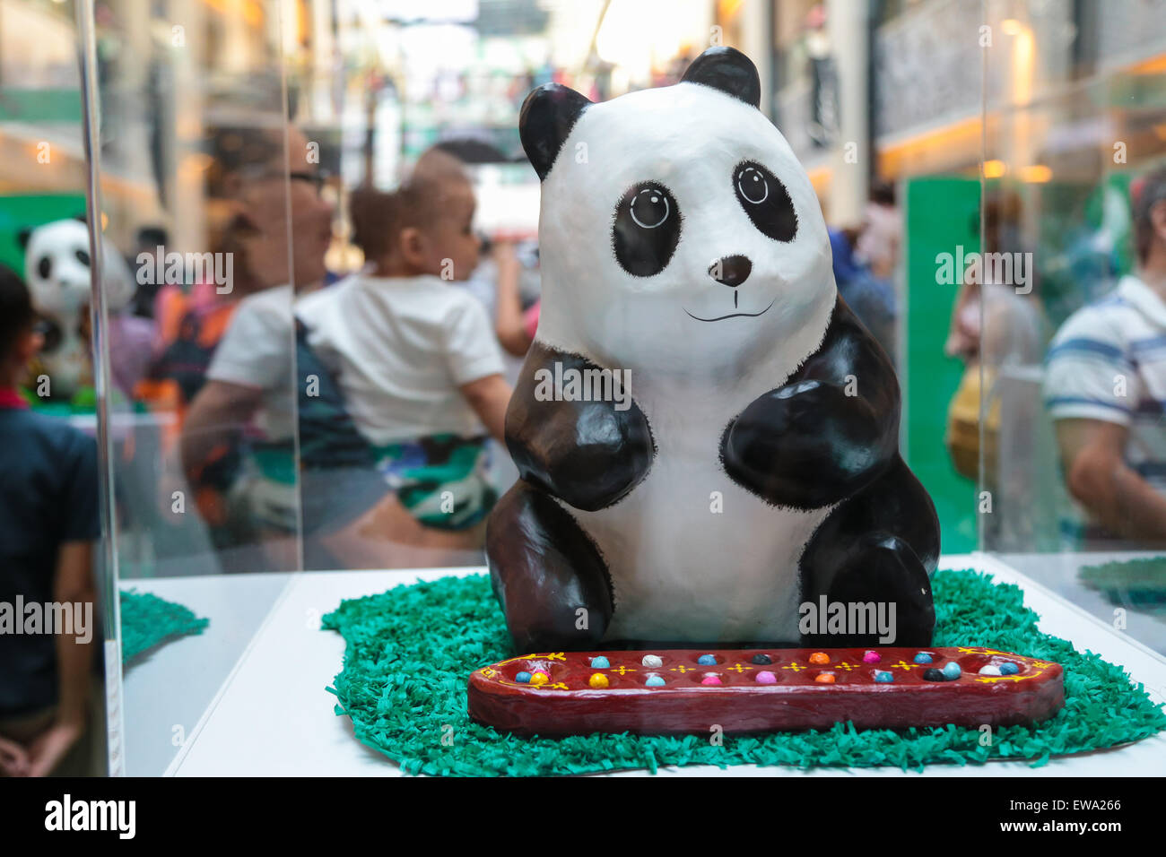 Mache panda playing congkak at 1600 Pandas campaign by WWF at Publika shopping mall to promote environmental preservation. Stock Photo