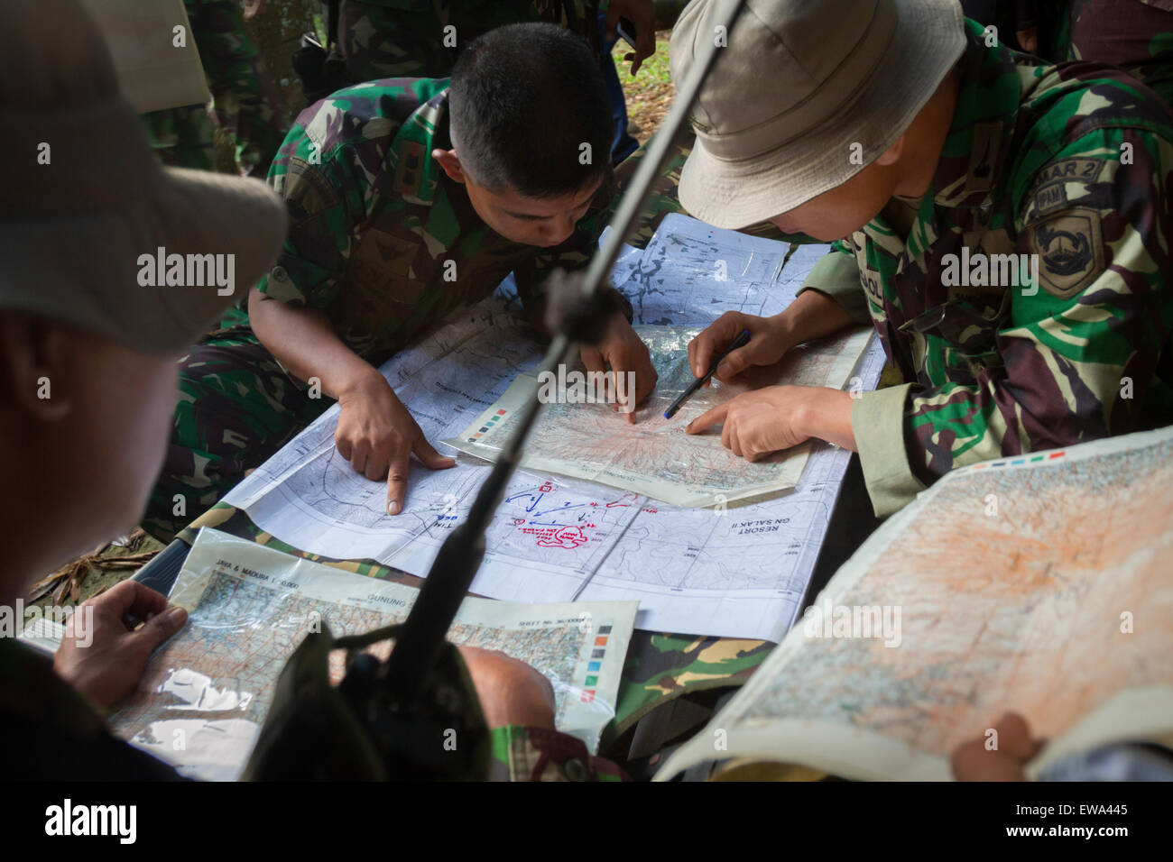 Mount Salak, West Java, Indonesia. May 10, 2012. Indonesian marines plotting the Sukhoi Superjet 100 crash site on map in Mount Salak region. Stock Photo