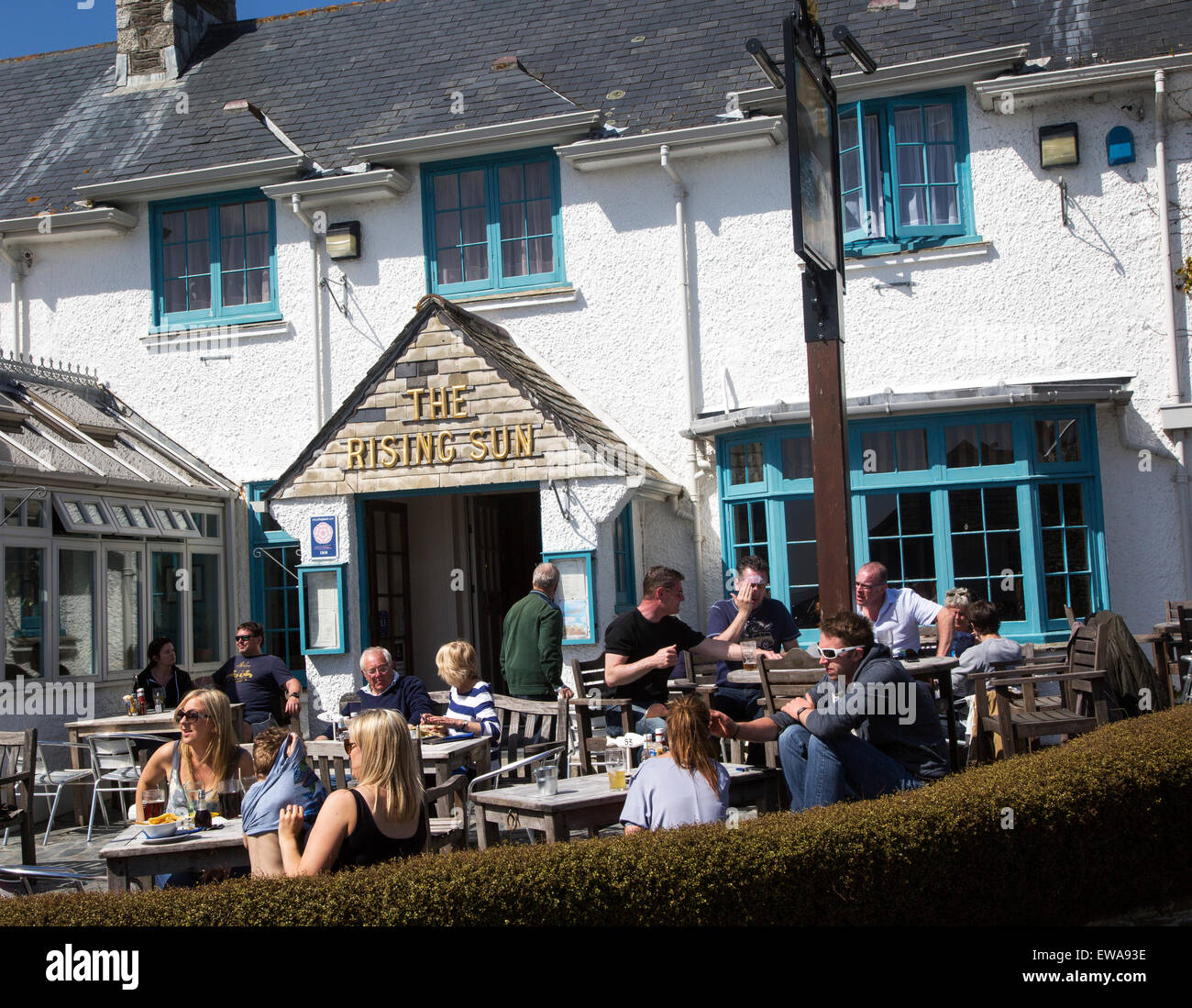 People sitting outside The Rising Sun pub, St Mawes, Cornwall, England, UK Stock Photo