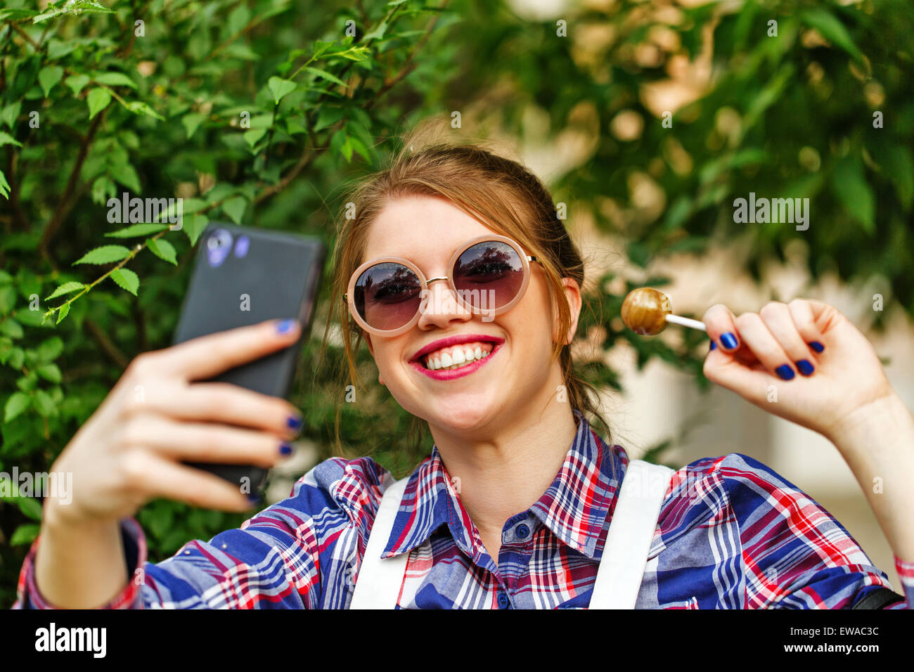 The Girl Photographed Herself On A Mobile Phone Selfie Style Images Toned In Warm Colors Girl With A Lollipop Stock Photo Alamy