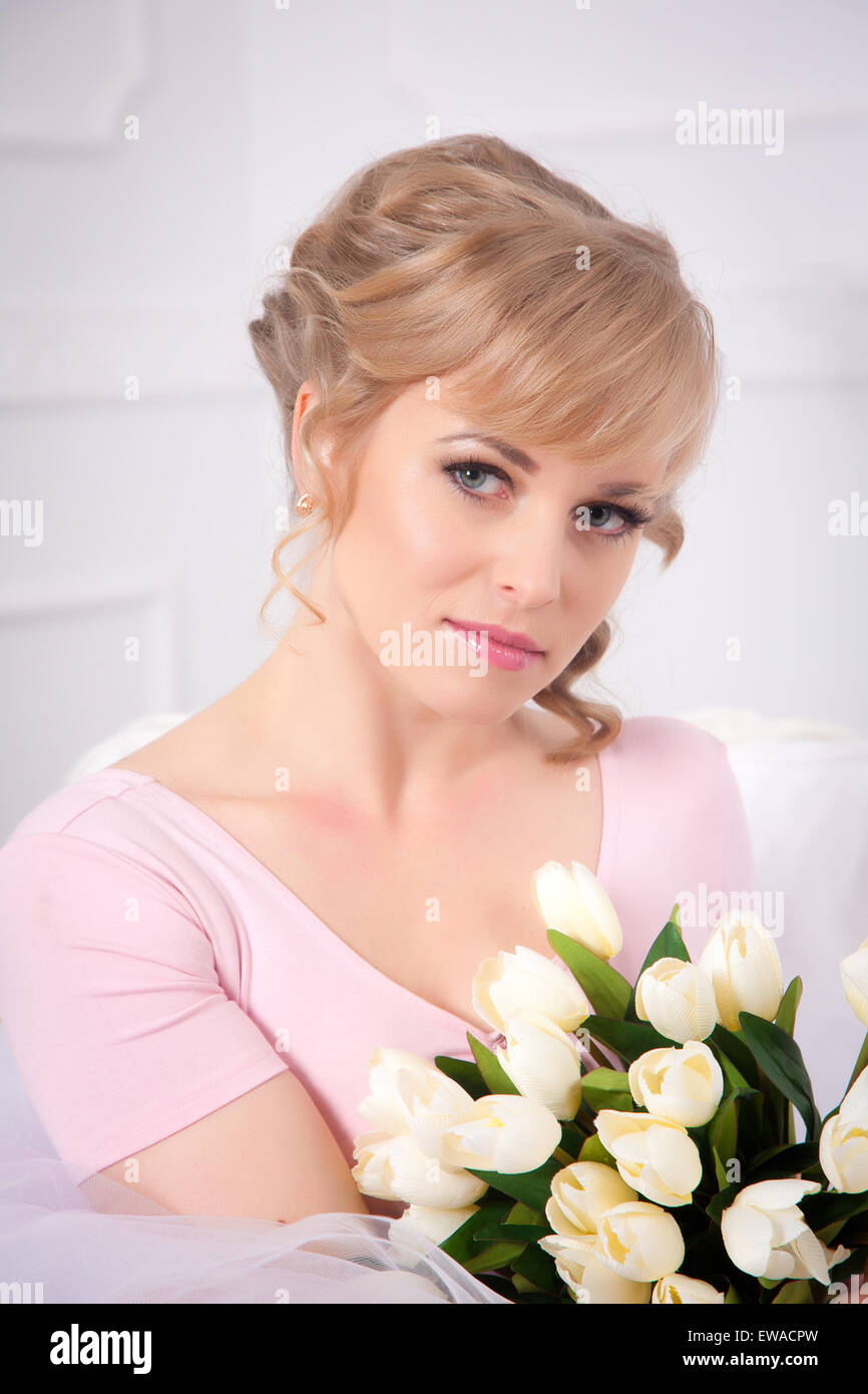 Beautiful blonde woman with a bouquet of tulips Stock Photo - Alamy