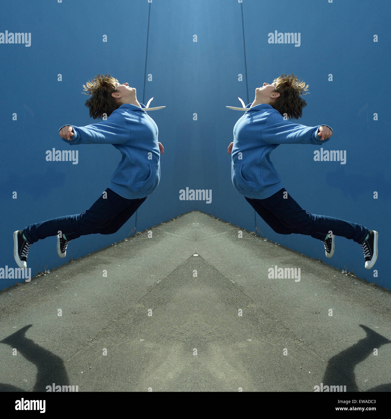 Mirrored, horizontally flipped image of 13 year old girl jumping toward sun Stock Photo