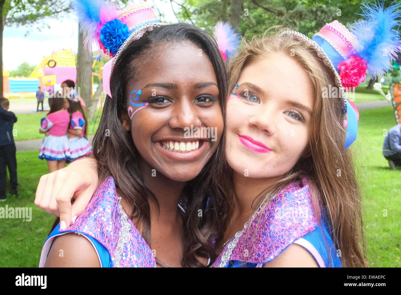 Young black and white girls embrace together a the Caribbean Carnival