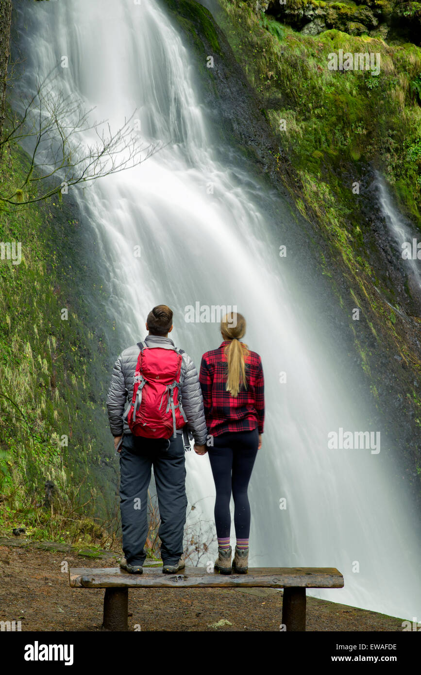 Young couple looking at Winter Falls. Silver Falls State Park, Oregon Stock Photo