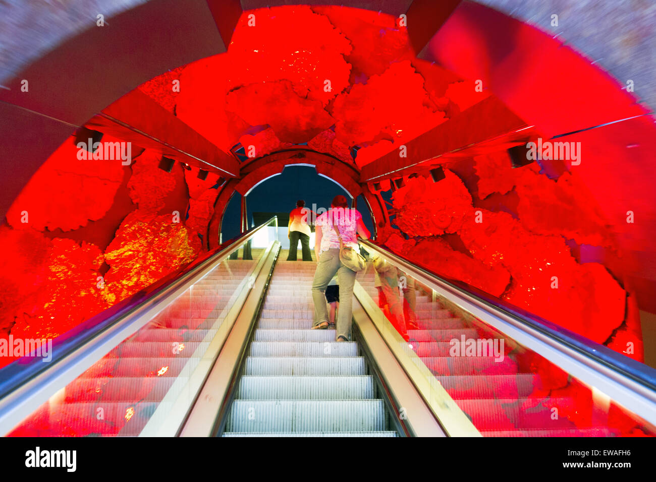 Escalator in the Science Museum, resembling an entry into a glowing planet. Stock Photo