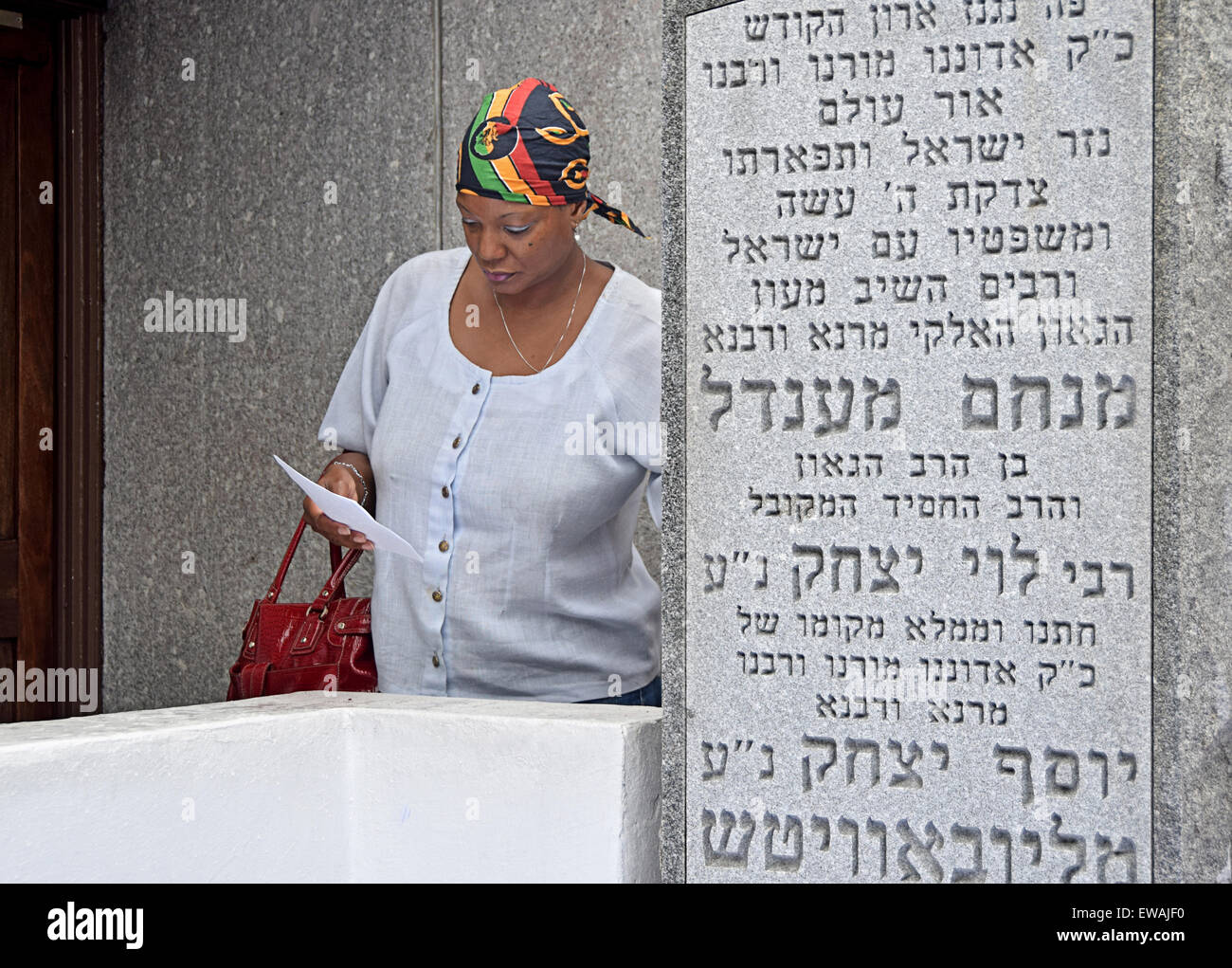 Portrait of a religious Christian woman reciting a personal prayer at a Jewish holy site in Cambria Heights, Queens, New York Stock Photo