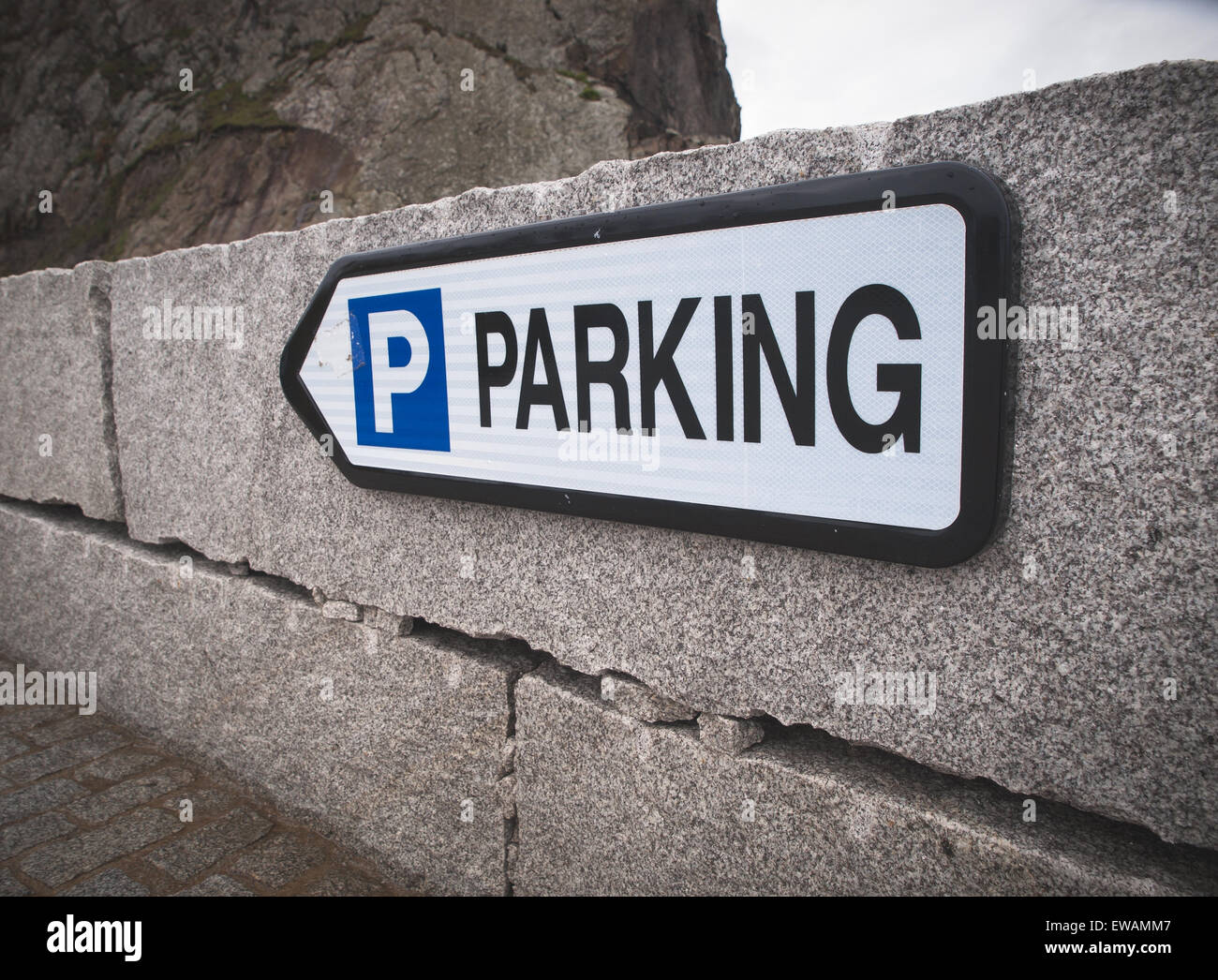 Parking sign in a stone wall outdoors Stock Photo