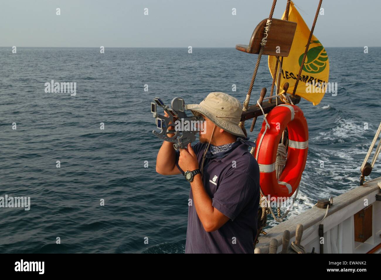 skipper on a sailboat takes the position with sextant Stock Photo Alamy