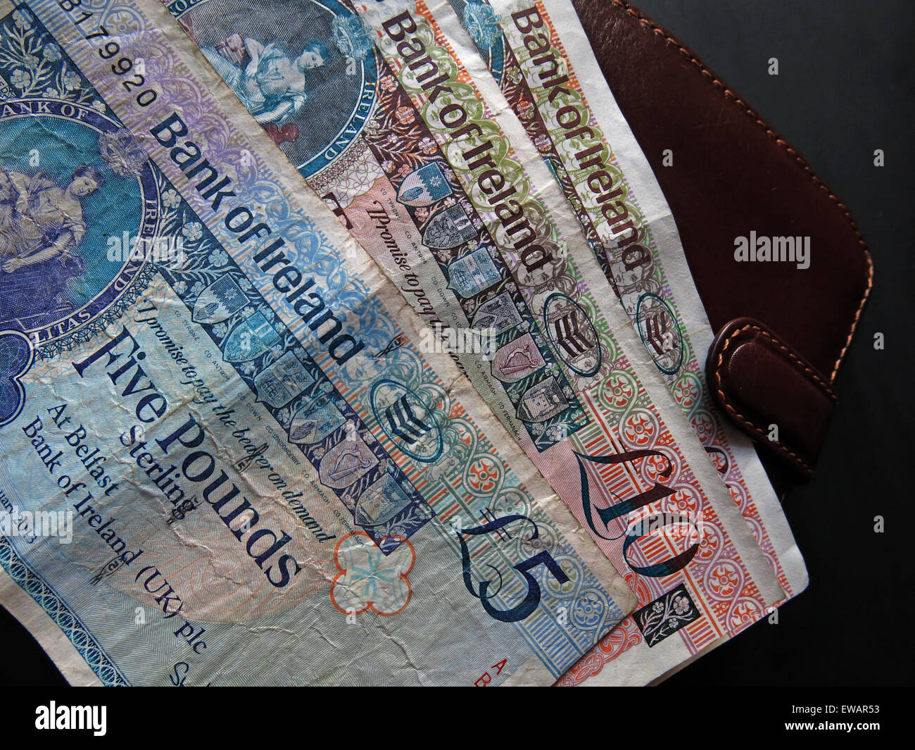 Northern Irish £5, £10 notes and pound coins, legal tender from the Bank Of Ireland  Belfast, next a wallet Stock Photo