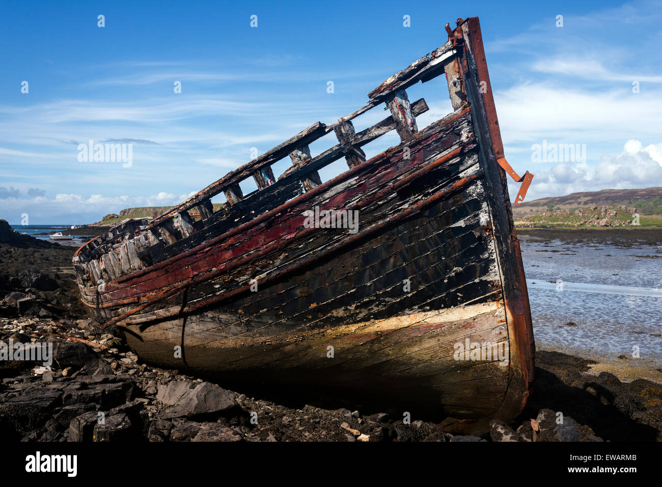 A single abandoned fishing boat at low tide on the banks of Loch a' Chumbainn Croig Isle of Mull Inner Hebrides Argyll Scotland Stock Photo