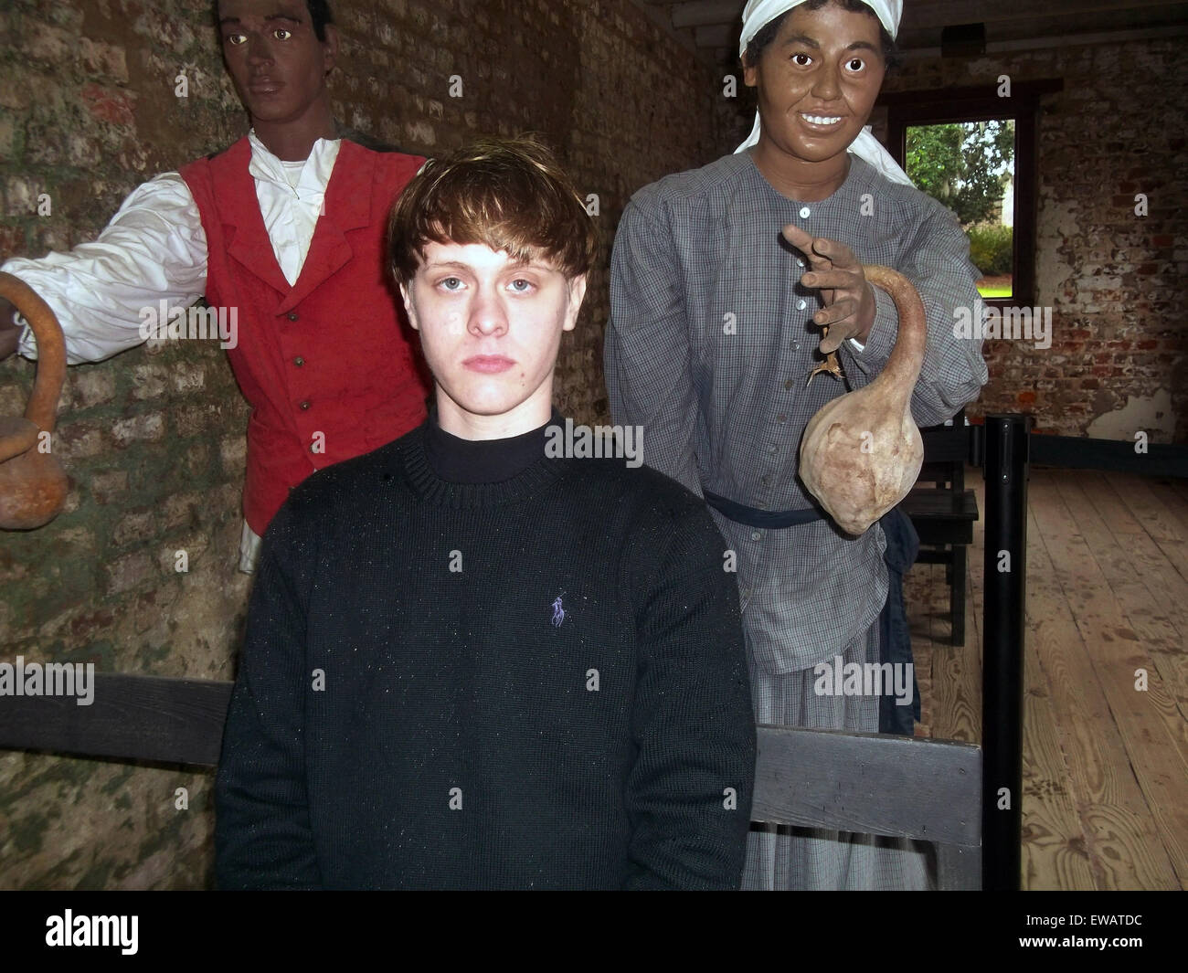 Charleston, South Carolina, USA. 21st June, 2015. A photo from a white supremacist website showing mass murderer Dylann Storm Roof sitting in a slave cabin museum exhibit August 3, 2014. Roof murdered nine members of the Emanuel African Methodist Episcopal Church in a racially motivated killing on June 17, 2015 in Charleston, S.C. Credit:  Planetpix/Alamy Live News Stock Photo