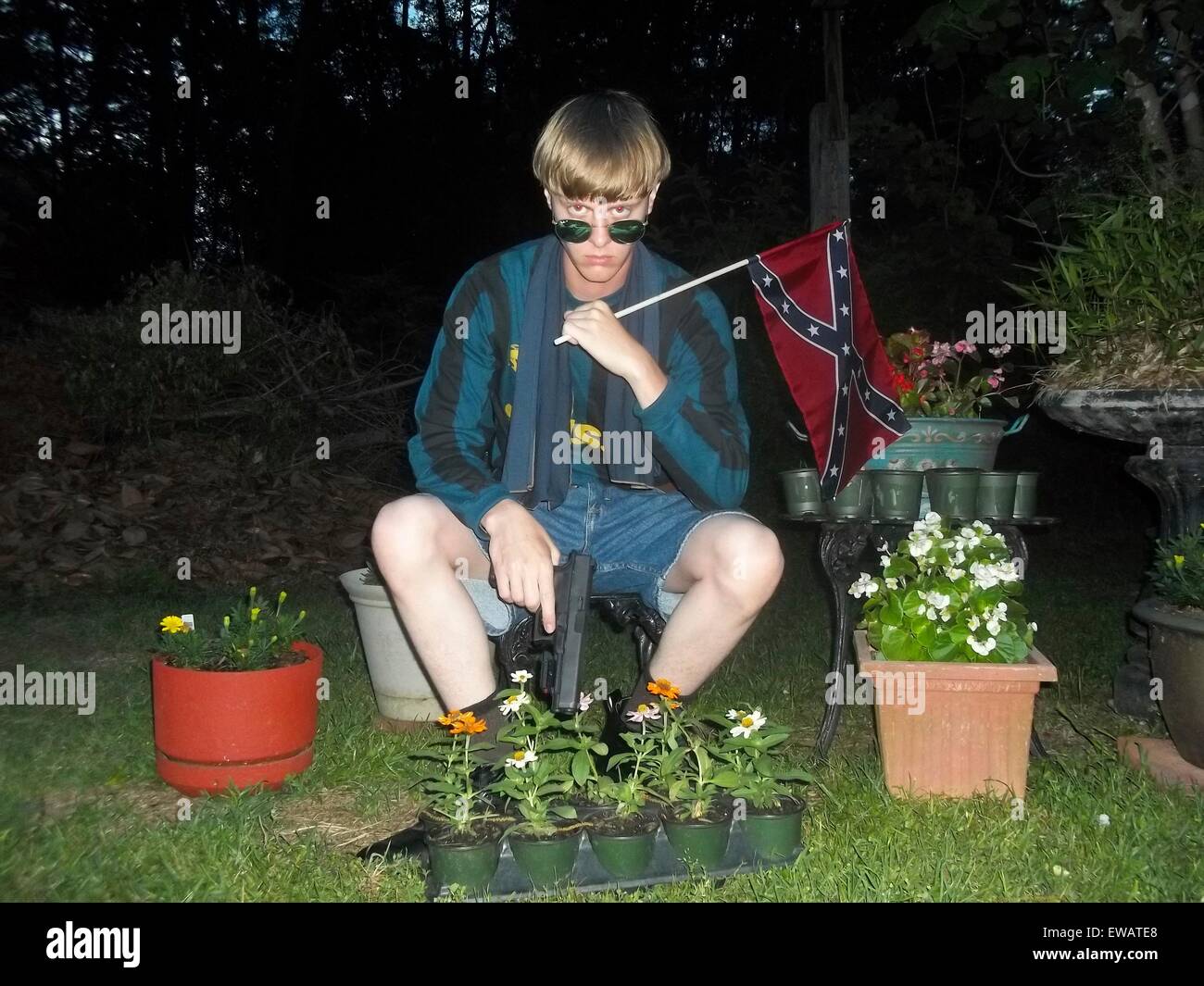 A photo from a white supremacist website showing Dylann Storm Roof sitting with his handgun and confederate flag April 27, 2015. Roof murdered nine members of the Emanuel African Methodist Episcopal Church in a racially motivated killing on June 17, 2015 in Charleston, S.C. Credit:  Planetpix/Alamy Live News Stock Photo