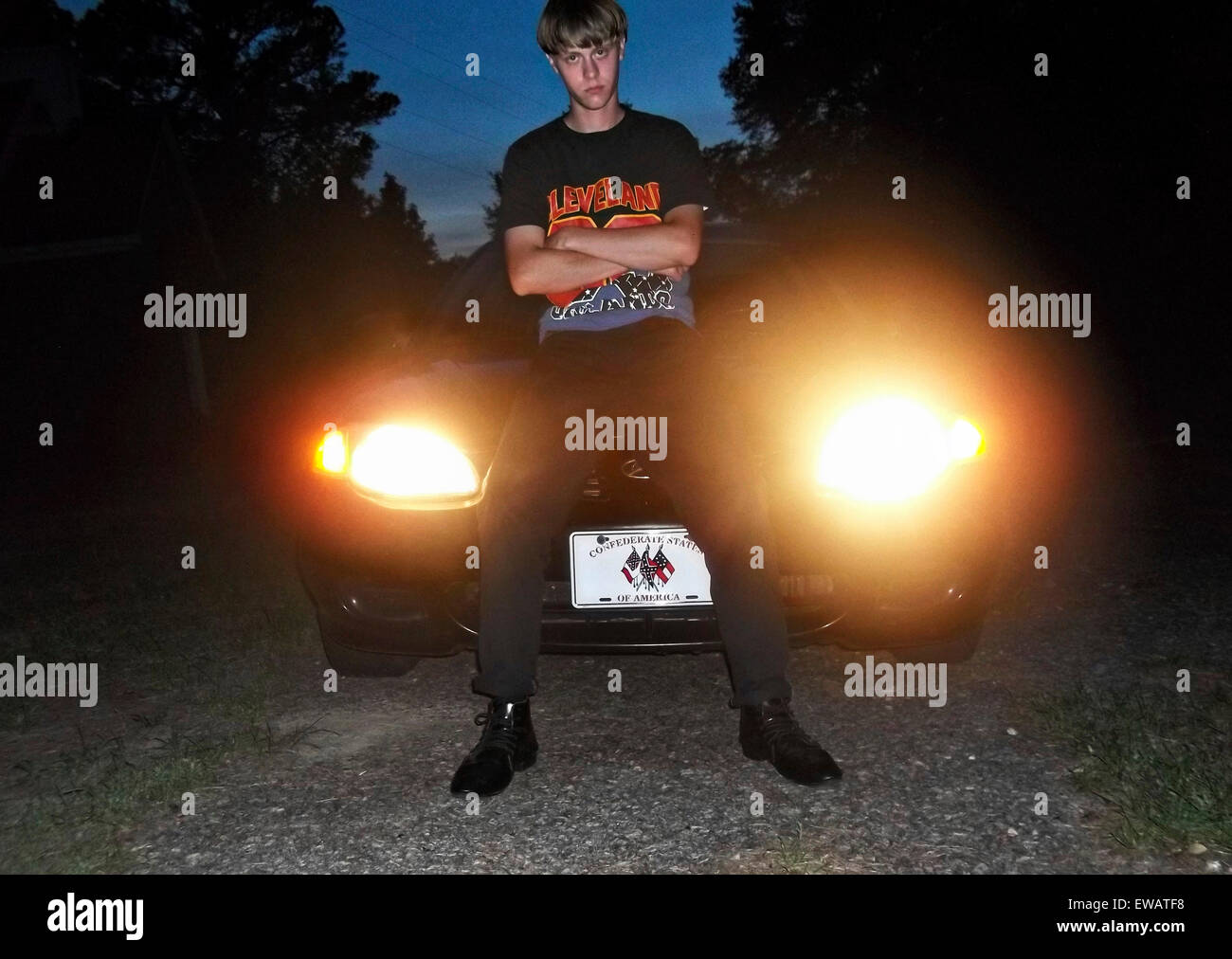 A photo from a white supremacist website showing Dylann Storm Roof sitting on his car with a confederate vanity plate April 30, 2015. Roof murdered nine members of the Emanuel African Methodist Episcopal Church in a racially motivated killing on June 17, 2015 in Charleston, S.C. Credit:  Planetpix/Alamy Live News Stock Photo