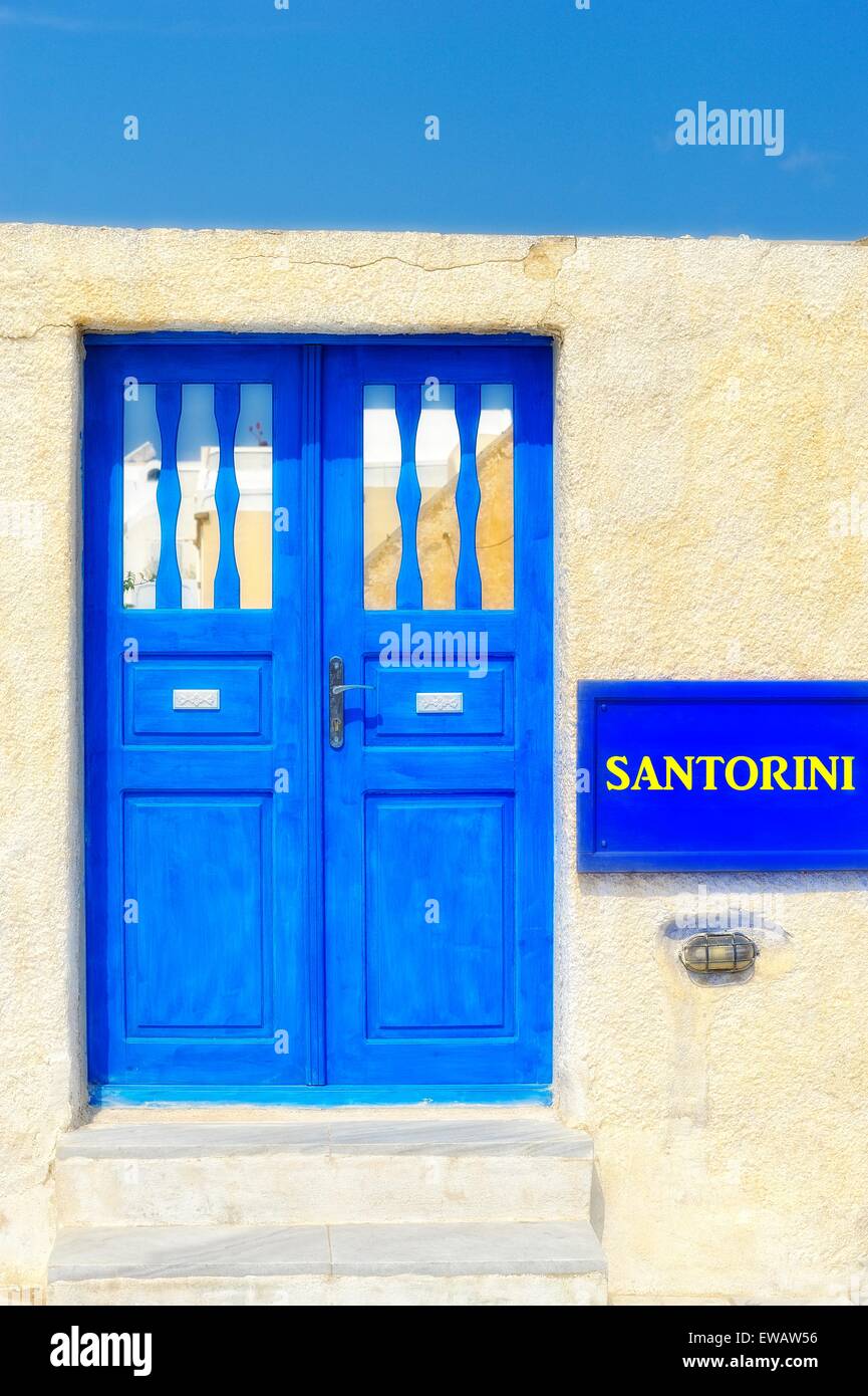 Blue painted doors on the island of Santorini Greece.(santorini digitally added to the blue sign) Stock Photo