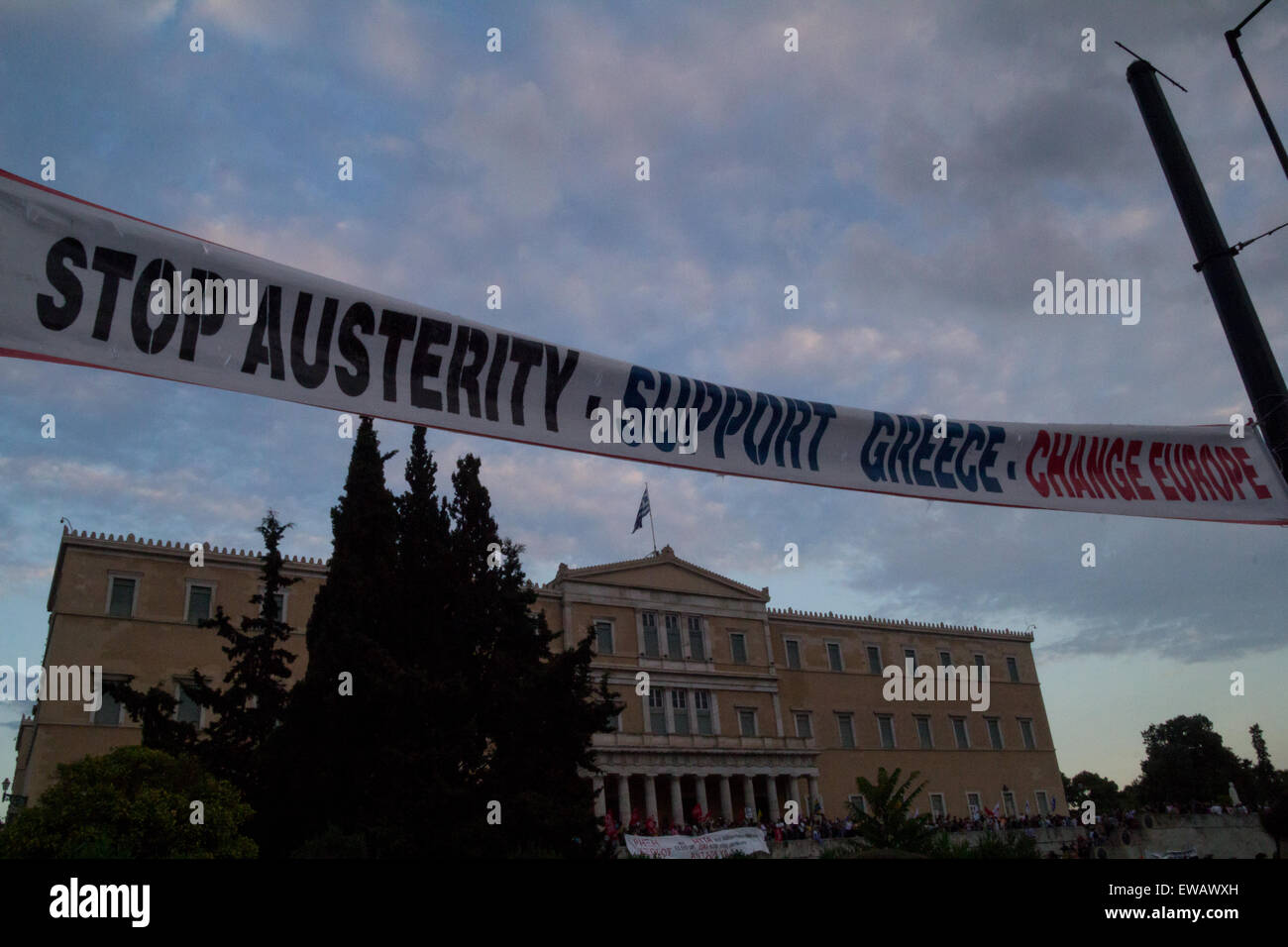 Athens, Greece. 21st June, 2015. An anti-austerity banner is seen in front of the Parliament building. Greeks demonstrate against austerity prior to Monday's 22nd July Eurogroup which is possible to decide if Greece remains or exits Eurozone. Credit:  Kostas Pikoulas/Pacific Press/Alamy Live News Stock Photo